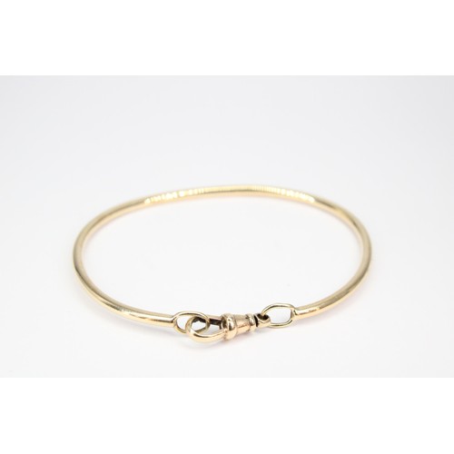40 - A bangle with toggle clasp. Tests 9ct. Weight 10.10 grams, approx 6cm internal diameter