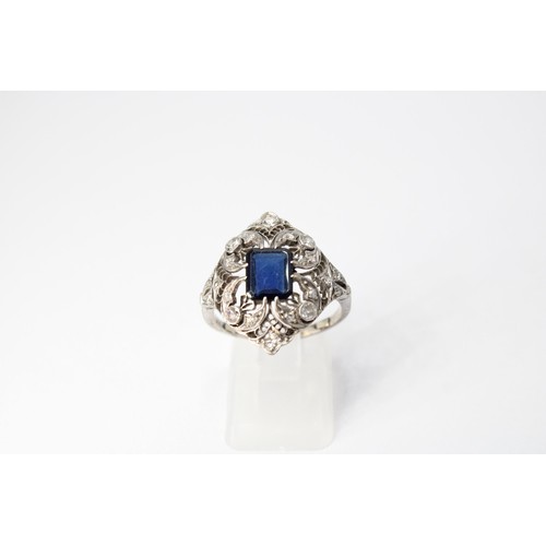 59 - A sapphire and diamond openwork cluster ring. Size R. Tests silver. Weight 4.20 grams