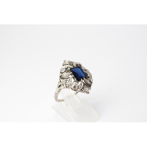 59 - A sapphire and diamond openwork cluster ring. Size R. Tests silver. Weight 4.20 grams