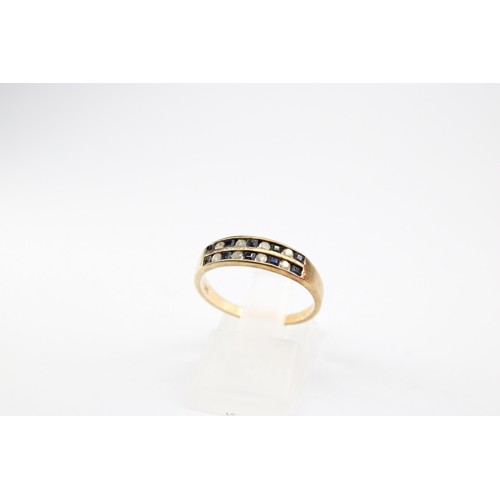 66 - A sapphire and diamond two row ring. Stamped 375. Size N 1/2. Weight 1.98 grams