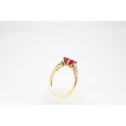 61 - An oval ruby and graduated brilliant cut diamond ring. Stamped 750. Size Q 1/2. Weight 3.23 grams