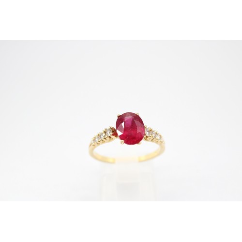 61 - An oval ruby and graduated brilliant cut diamond ring. Stamped 750. Size Q 1/2. Weight 3.23 grams