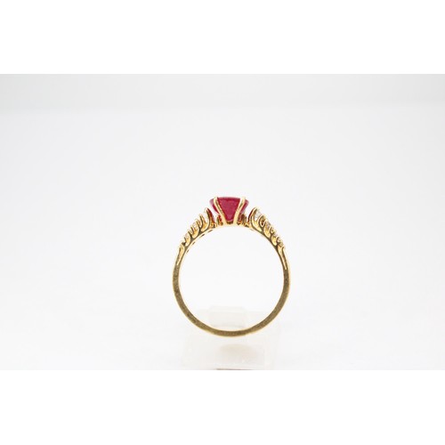 61 - An oval ruby and graduated brilliant cut diamond ring. Stamped 750. Size Q 1/2. Weight 3.23 grams