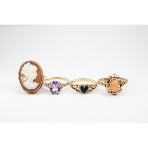 68 - Four rings with marks indicating 9ct gold. To include a cameo ring size L 1/2, an onyx heart ring si... 