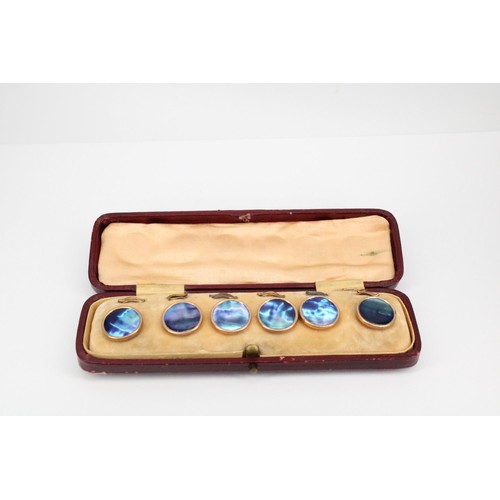76 - A set of six dress studs. Believed to be abalone pearl with 9ct rims and yellow metal fittings. In f... 