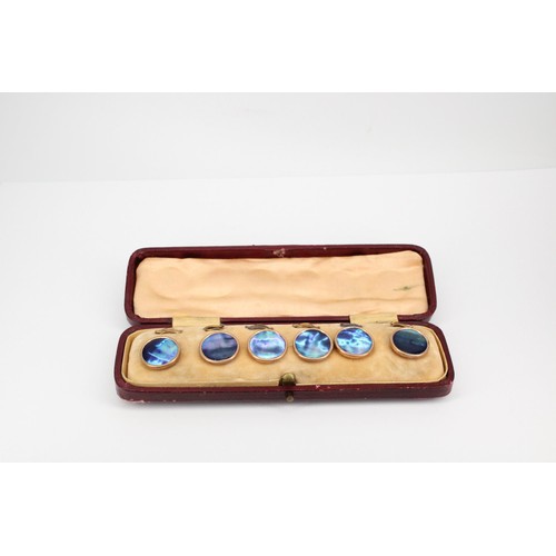 76 - A set of six dress studs. Believed to be abalone pearl with 9ct rims and yellow metal fittings. In f... 