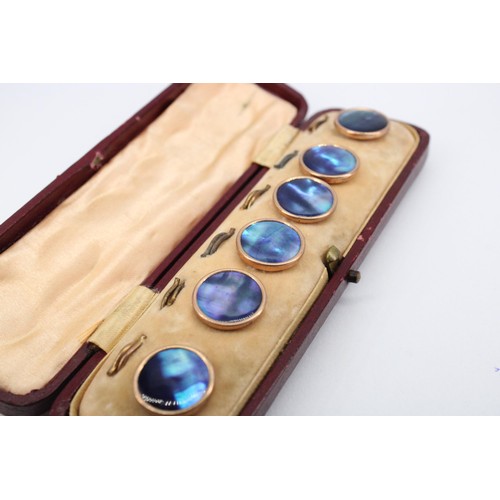 76 - A set of six dress studs. Believed to be abalone pearl with 9ct rims and yellow metal fittings. In f... 