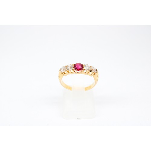 17 - An 18ct Ruby and Diamond Eternity ring, featuring a tapered detailed shoulder design. Approximately ... 