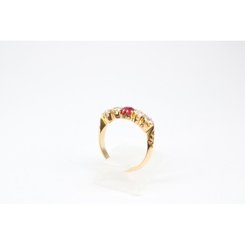17 - An 18ct Ruby and Diamond Eternity ring, featuring a tapered detailed shoulder design. Approximately ... 