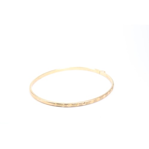 84 - A 9ct Thin 'Wire' Bangle with Textured Design&nbsp;Weight: 3.47g Internal Diameter: 6cm&nbsp;... 