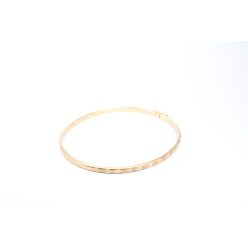 84 - A 9ct Thin 'Wire' Bangle with Textured Design&nbsp;Weight: 3.47g Internal Diameter: 6cm&nbsp;... 