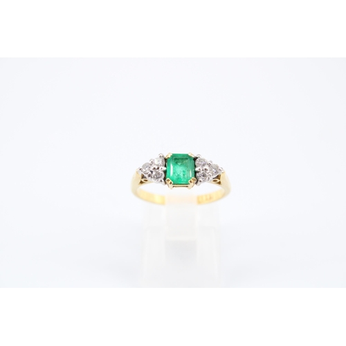 14 - An 18ct Emerald & Diamond Ring, Featuring a Central Radiant Cut Emerald with clusters of three d... 