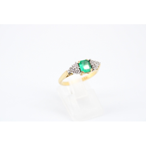 14 - An 18ct Emerald & Diamond Ring, Featuring a Central Radiant Cut Emerald with clusters of three d... 