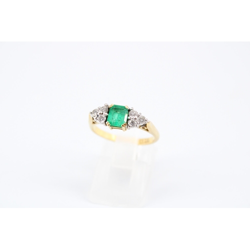 14 - An 18ct Emerald & Diamond Ring, Featuring a Central Radiant Cut Emerald with clusters of three d... 