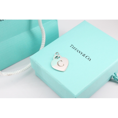 2 - A Tiffany & Co. sterling silver 'C' charm - approx weight 5.66g, approx width 2cm - with box, ba... 