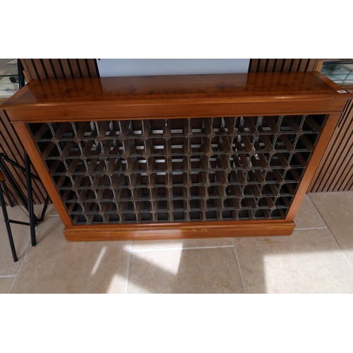 631 - A walnut wine rack holding 104 bottles - Width 135cm x Height 88cm