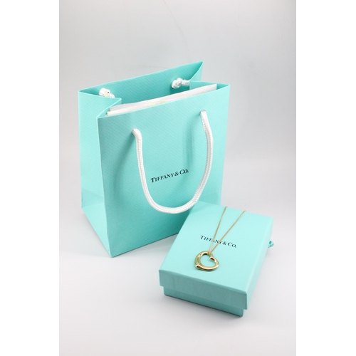 8 - A Tiffany & Co Elsa Peretti  'Open Heart' pendant with hallmarks for 18ct gold on a 9ct yellow g... 