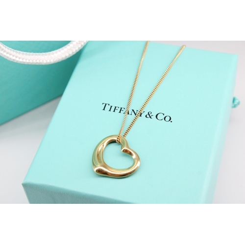 8 - A Tiffany & Co Elsa Peretti  'Open Heart' pendant with hallmarks for 18ct gold on a 9ct yellow g... 