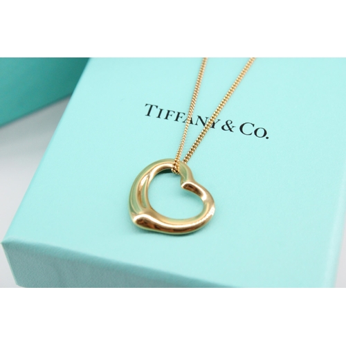 8 - A Tiffany & Co Elsa Peretti  'Open Heart' pendant with hallmarks for 18ct gold on a 9ct yellow g... 