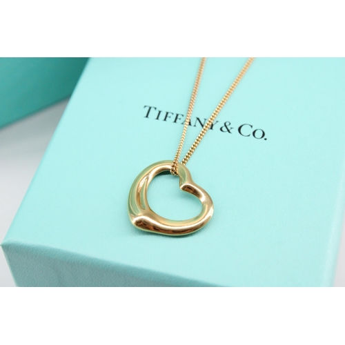 8 - A Tiffany & Co Elsa Peretti  'Open Heart' pendant with hallmarks for 18ct gold on a 9ct yellow g... 