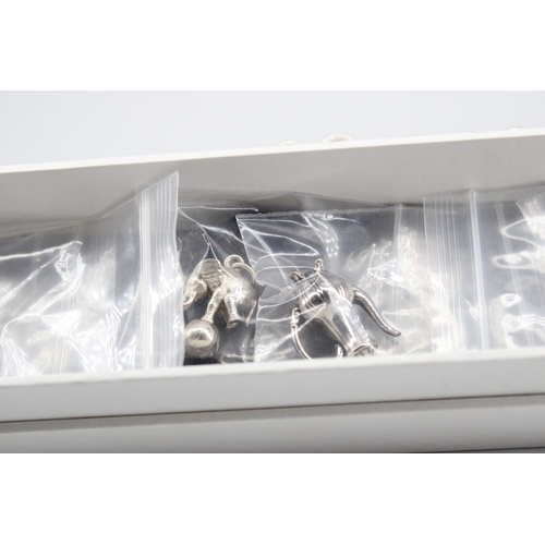 9 - A Stephen Einhorn sterling silver charm bracelet with 7 charms and spare links - charms to include L... 