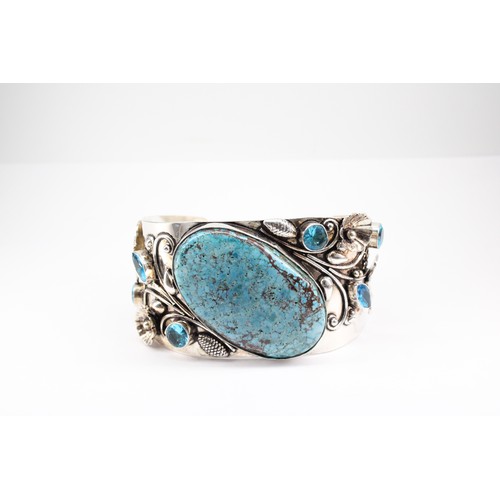 21 - An Unusual Large Silver Turquoise and Blue Stone Bangle with an Intricate Design of Butterflies and ... 