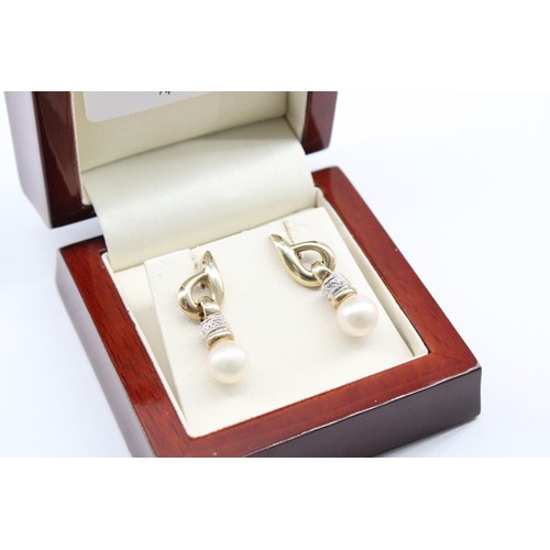 22 - A&nbsp;9ct Yellow Gold Pearl Drop Ear Rings with a Diamond Collar, Length approx.&nbsp;25mm, Pearls ... 