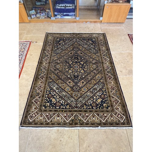 584 - A hand knotted woollen Qom silk inlaid rug - 2.10m x 1.43m