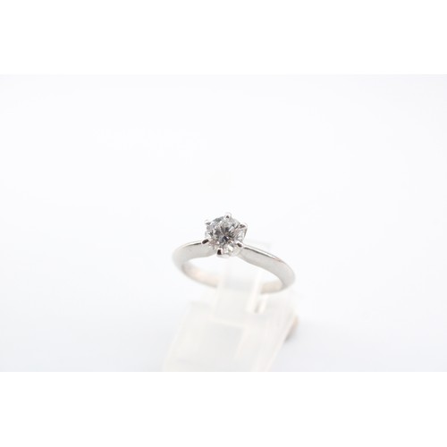 2 - A 0.71 Carat Diamond Solitaire, Featuring a Central Round Brilliant Diamond E, 2I 1 Set in Platinum.... 