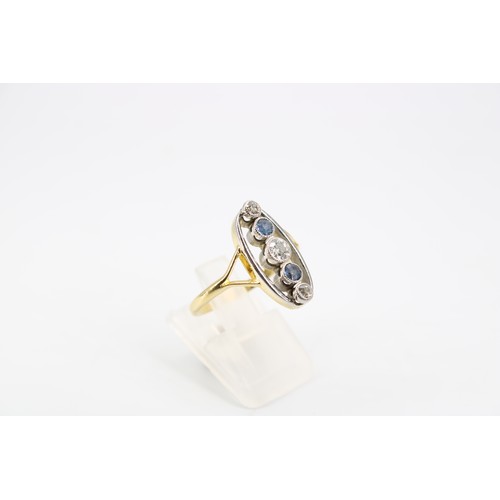 10 - An 18ct Edwardian Style Sapphire and Diamond Ring, Featuring a central oval head with pierced split ... 
