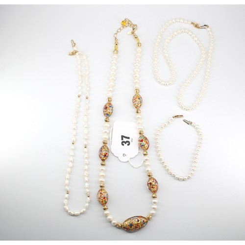 37 - Two freshwater cultured pearl necklaces and a bracelet. Clasps stamped 14k. Together with a freshwat... 