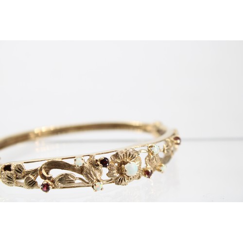 32 - A 9ct Opal & Garnet Bangle with Pierced Floral Panel&nbsp;Weight: 14.30g Internal Diameter: 6.5c... 
