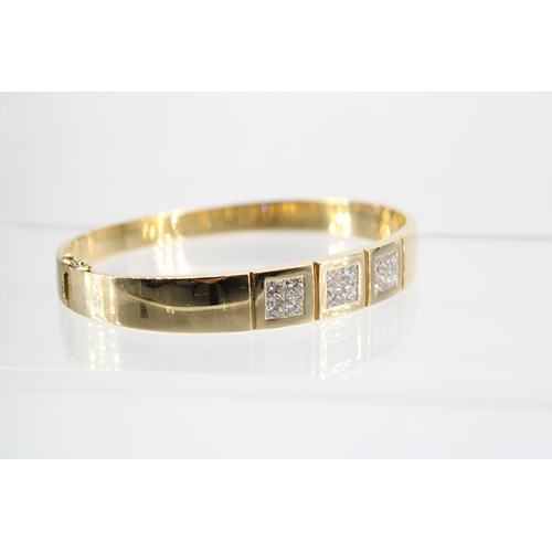 13 - An 18ct Diamond Bangle Featuring a central panel of 12 Individual Set Princess Cut Stones, Approxima... 