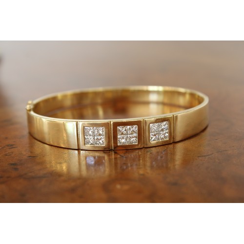 13 - An 18ct Diamond Bangle Featuring a central panel of 12 Individual Set Princess Cut Stones, Approxima... 