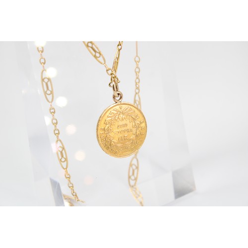 29 - A 20 Francs coin pendant, suspended from a fancy link chain. Tests 22ct. Bolt ring clasp stamped 9ct... 