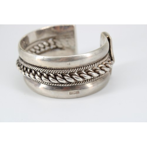 30 - A silver Egyptian cuff bangle. Weight 107.19 grams