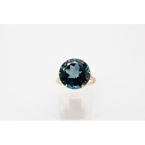 43 - A London blue topaz single stone ring. Size N 1/2. Stamped 10K. Weight 4.67 grams