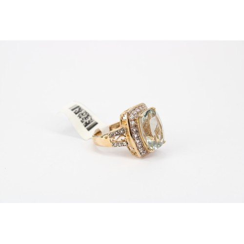 44 - A praisolite and white gem cluster ring. Size O. Stamped 10K. Weight 7.55 grams