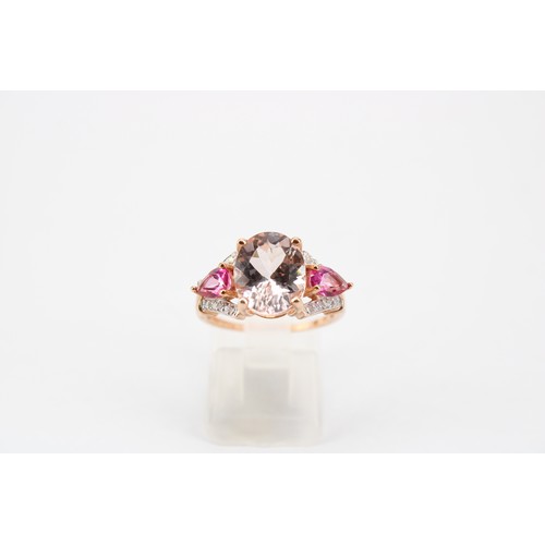 45 - A morganite, diamond and synthetic ruby dress ring. Size N 1/2. Stamped 10K. Weight 3.33 grams