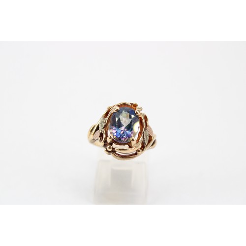46 - A synthetic colour change sapphire bi-colour dress ring. Size M. Stamped 10K. Weight 5.57 grams
