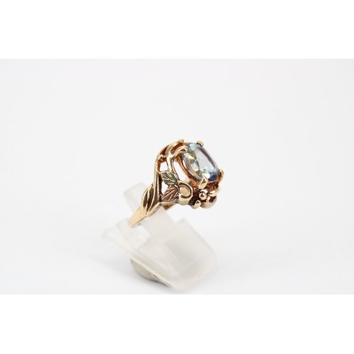 46 - A synthetic colour change sapphire bi-colour dress ring. Size M. Stamped 10K. Weight 5.57 grams