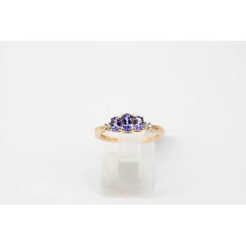48 - A marquise sapphire and diamond cluster ring with crossover shoulders. Stamped 10K. Size N 1/2. Weig... 