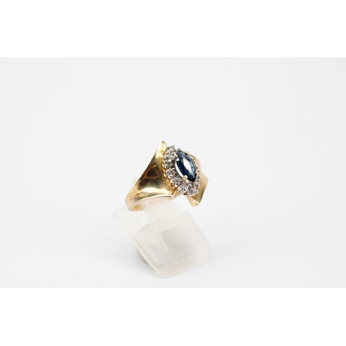49 - A tanzanite and diamond dress ring. Size O. Stamped 10K. Weight 1.80 grams