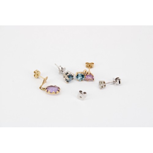 57 - A group of four diamond and gem set single earrings and extra butterfly Test 14kt. Weight 2.92 grams