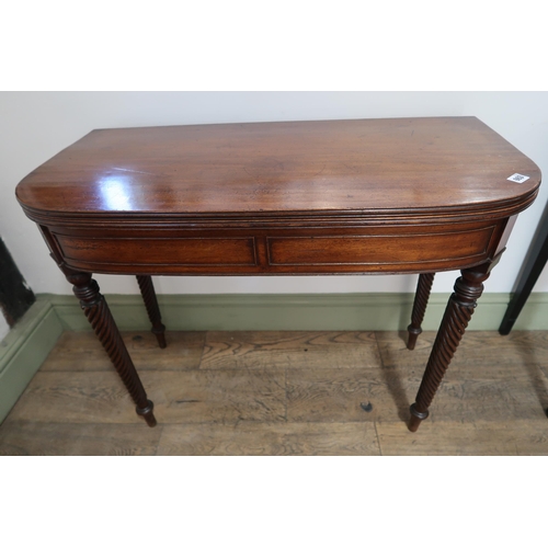 663 - A good quality Regency mahogany fold over tea table with four twisted legs, with a very good patina ... 