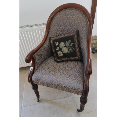  A Regency mahogany scroll arm library chair on brass casters