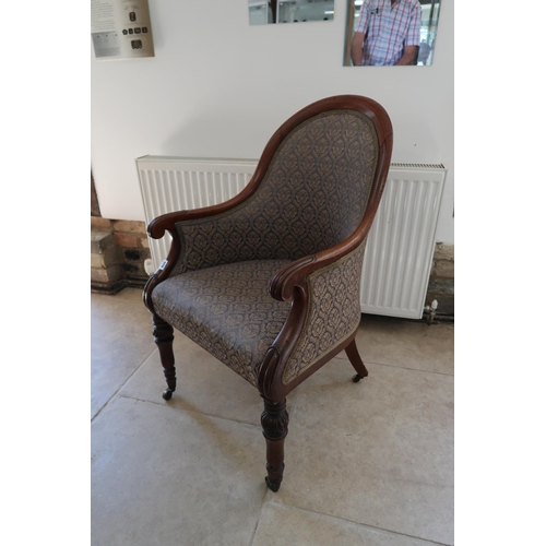  A Regency mahogany scroll arm library chair on brass casters