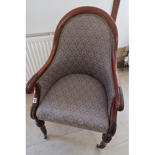  A Regency mahogany scroll arm library chair on brass casters