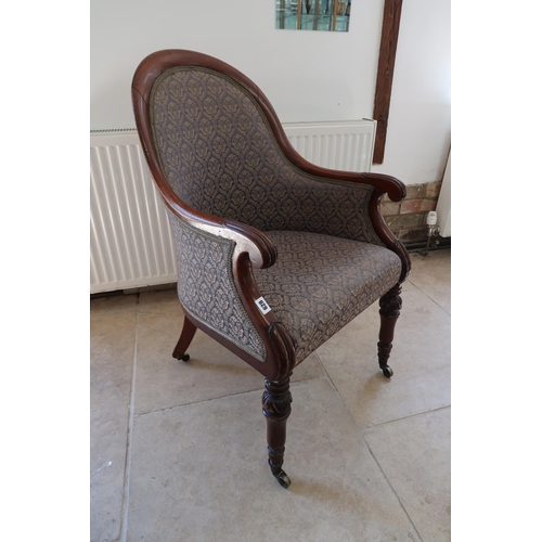  A Regency mahogany scroll arm library chair on brass casters