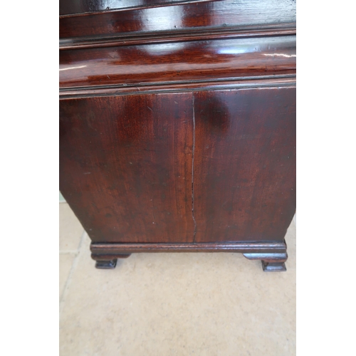  An 8 day mahogany grandfather clock with a brass face and moonroller dial with a plaque signed Geo M... 